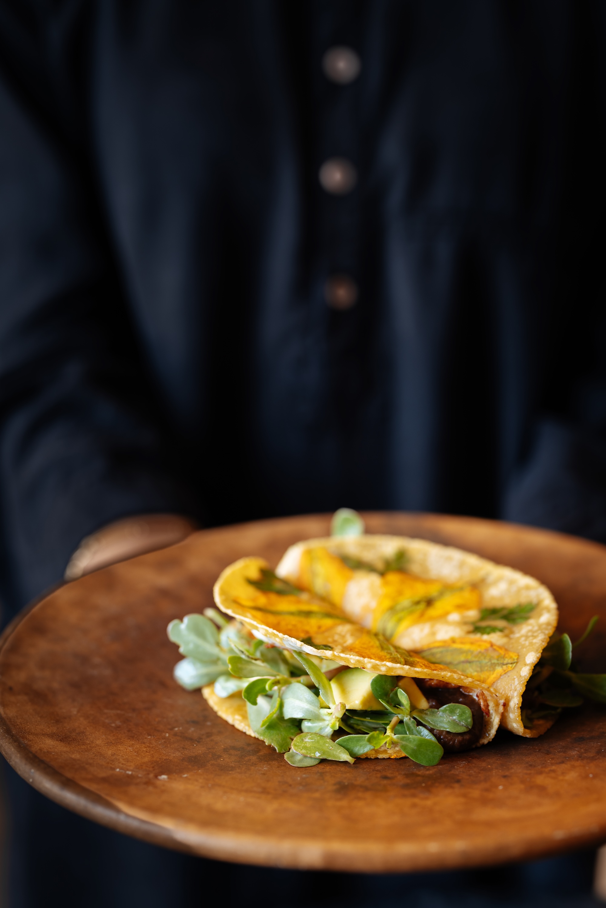 A mushroom, purslane and panela taco with zucchini-flower tortilla A mushroom, purslane and panela taco with zucchini-flower tortilla